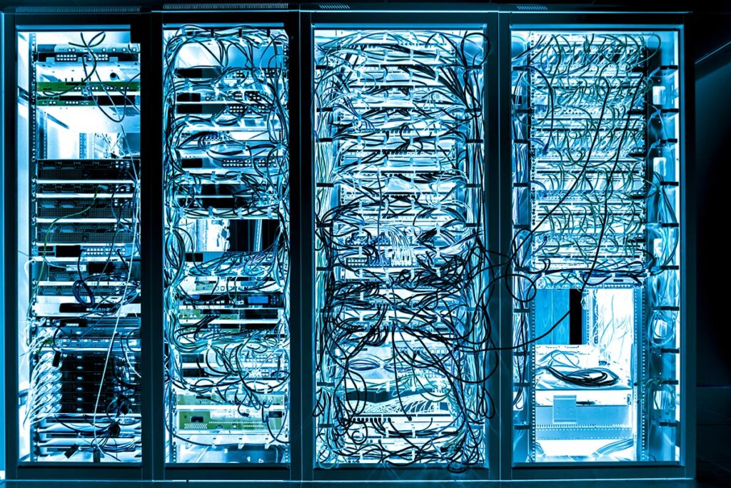 mess of blue wires in jumbled up in racks of servers